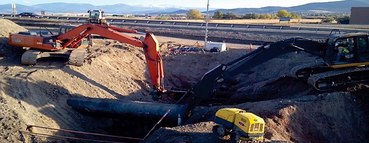 This is a photo two excavators digging a hole in the ground.